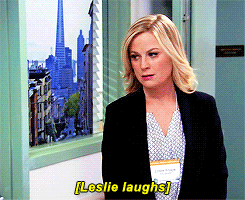 leslie knope parks and rec laughs facing wall gif